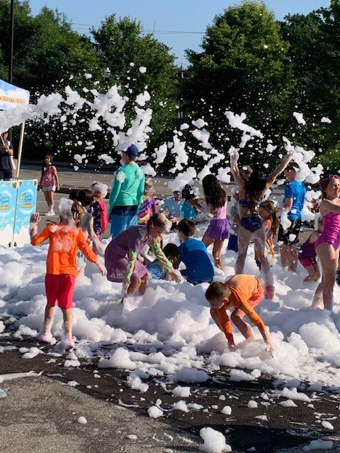 Youth and adults dressed for summer play in foam 